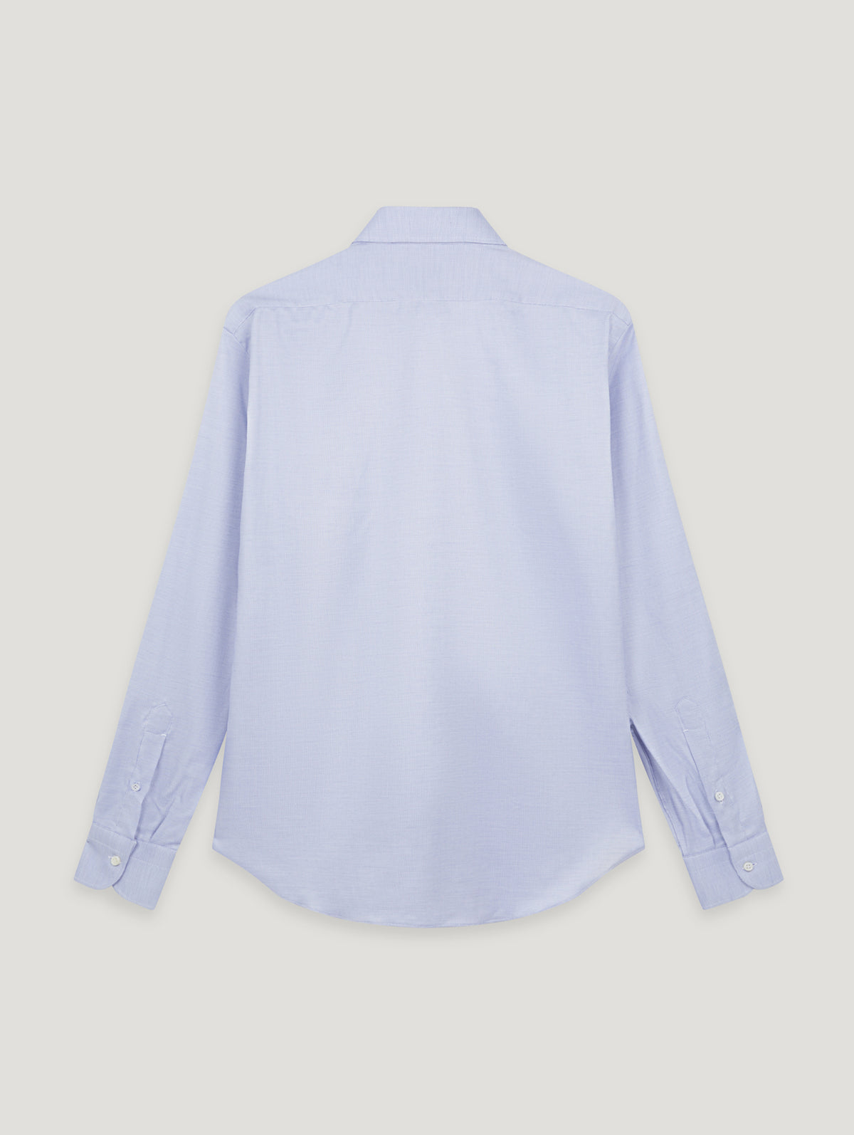 A light blue long-sleeve button-up shirt shown from the back, laid flat against a solid light gray background.